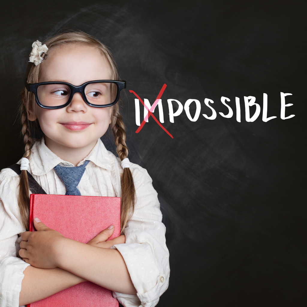 Smart kid with red book and putting a cross over impossible on blackboard background